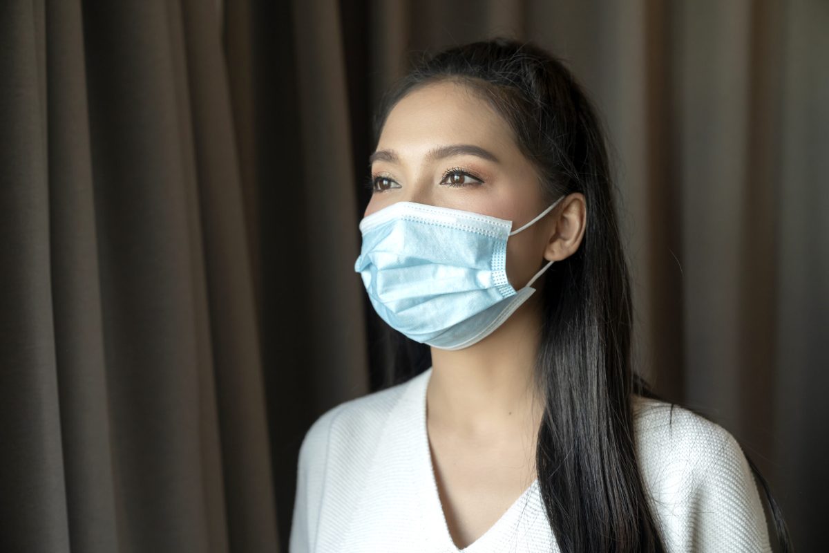 Portrait of Asian young female wear face medical mask. pandemic coronavirus disease quarantine in home. Covid-19 outbreak prevention concept.